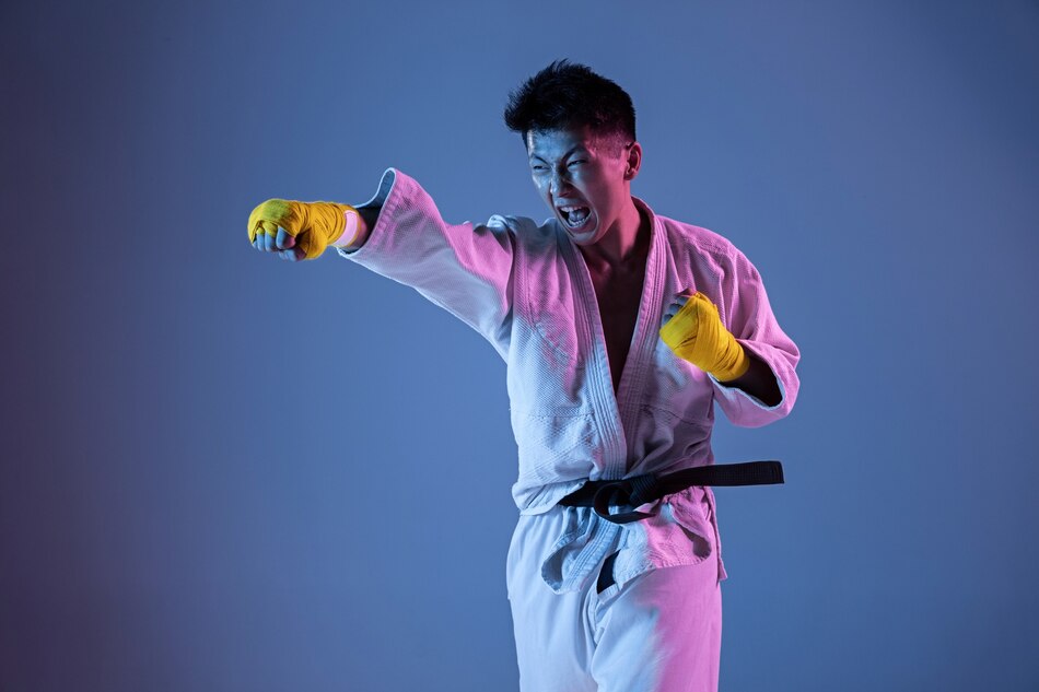 confident-korean-man-kimono-practicing-hand-hand-combat